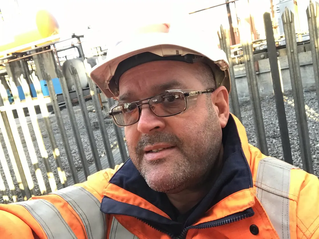 Darren Emery on site in a hard hat and high-visibility jacket
