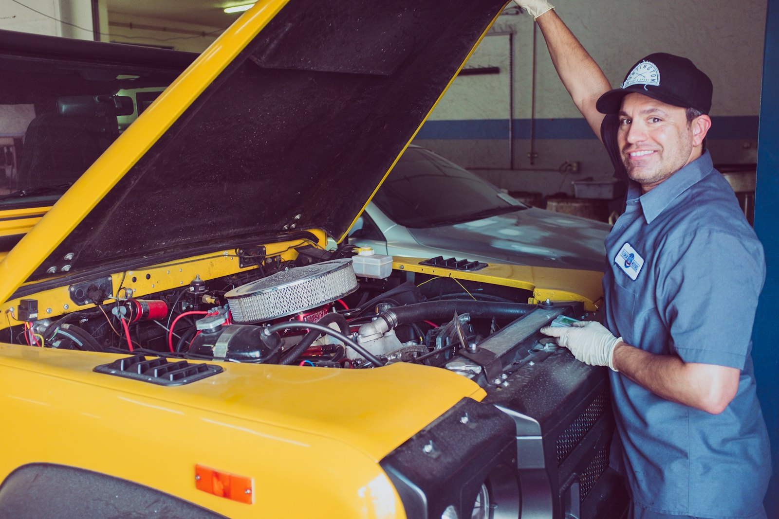 A smiling mechanic at work in his garage